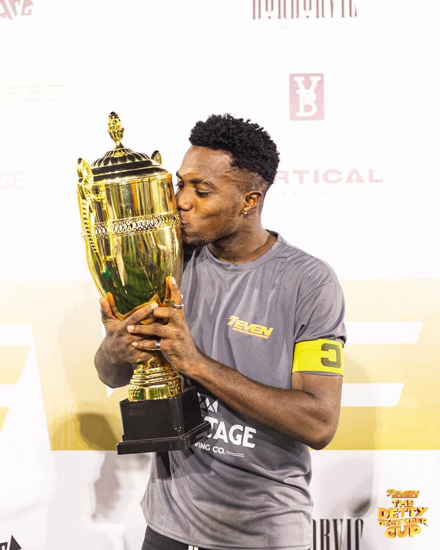 Captain kissing the Detty December Cup trophy